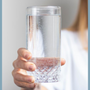 Woman holding glass of pure filtered water