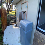 AquaCo-Water-Softener+Twin-Whole-House-Water-Filter-Combo classic installed rendered brick wall