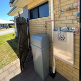 AquaCo-Water-Softener+Twin-Whole-House-Water-Filter-System Combo premium installed outside on brick wall